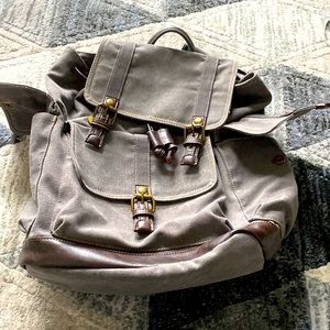 Brown backpack with magnetic clasps and drawstring